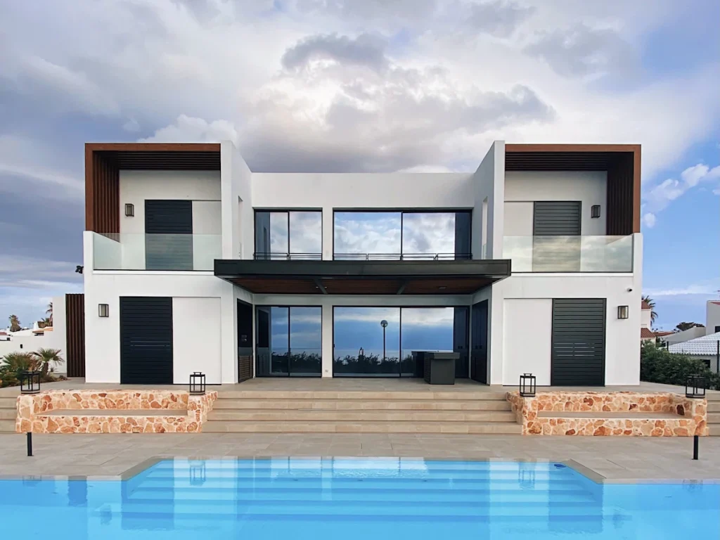 Contemporary two-storey villa with large glazing and a swimming pool in front